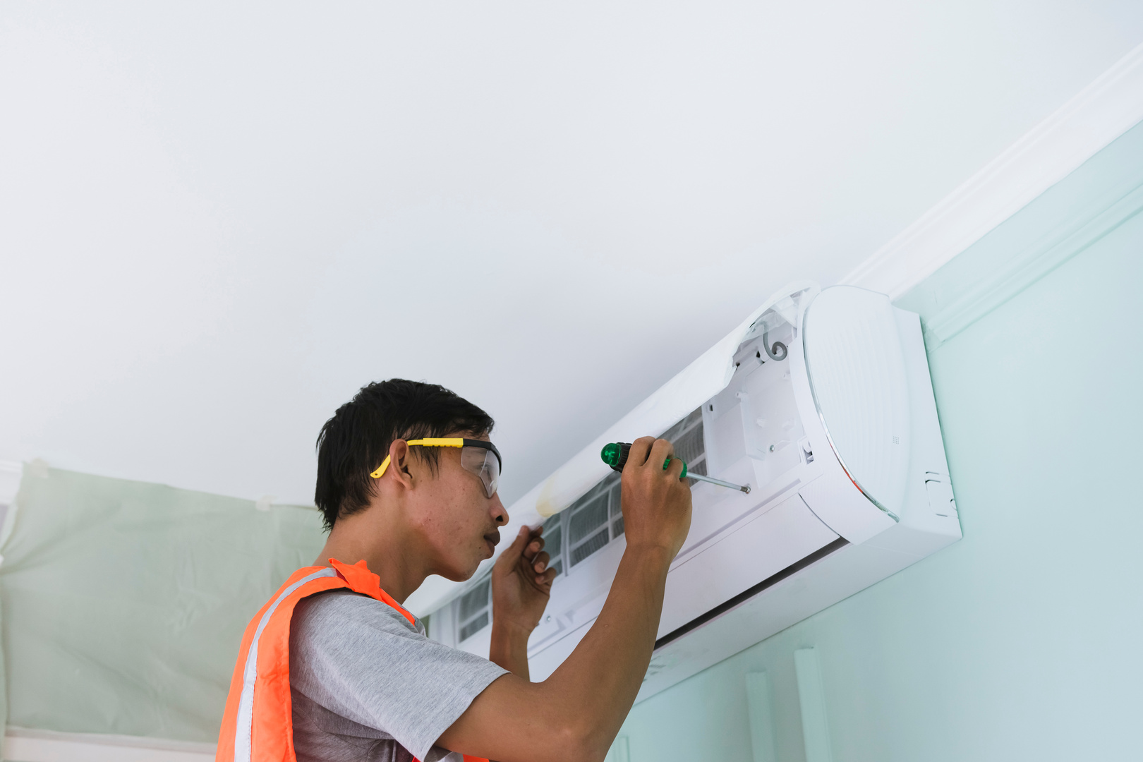 Man Repairing the Air Conditioning Unit